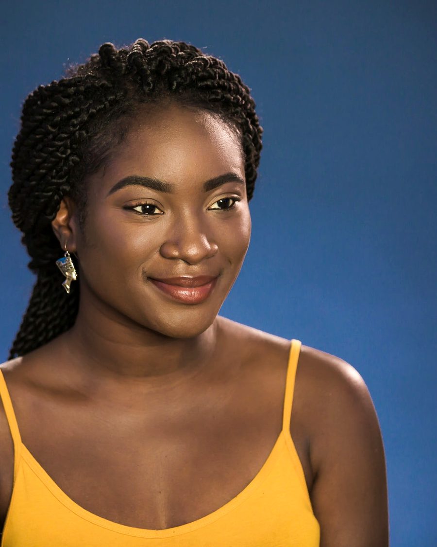 A young woman smiling in warm light